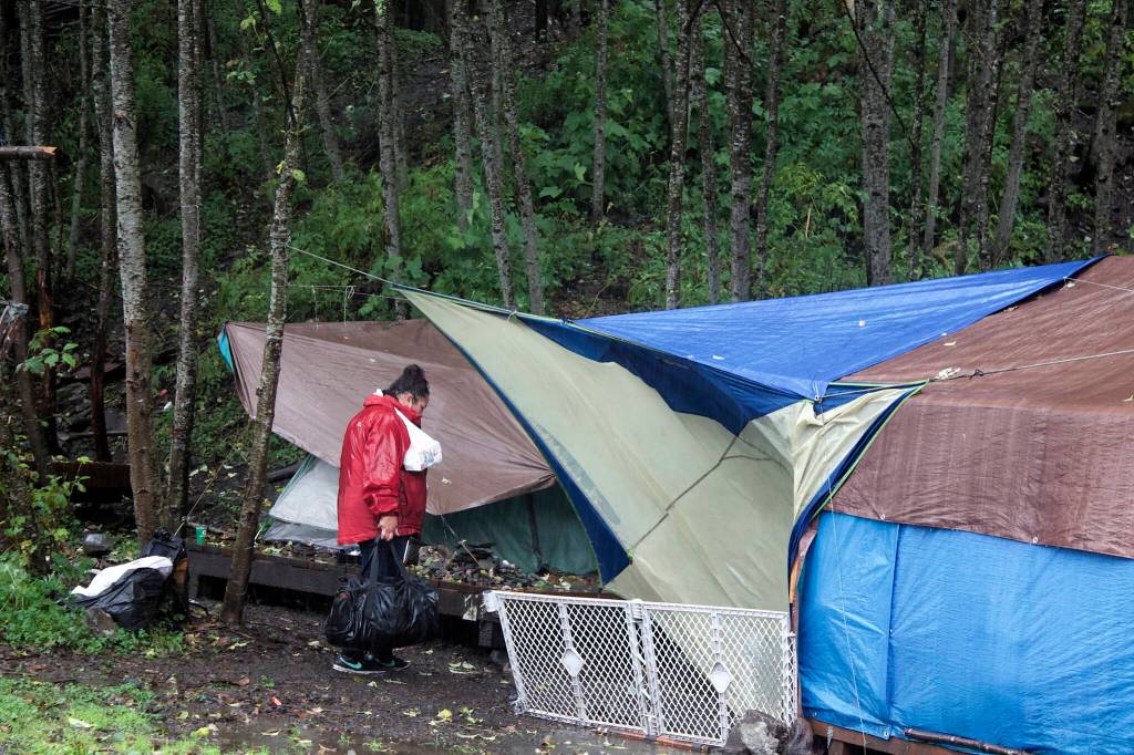 Mark Sabbatini / Juneau Empire 
Shelly Stevens carries groceries from a food pantry to her tent at Mill Campground on Monday. She has been homeless for the past 10 years, saying that raising four children kept her from the workplace and her addiction problems since have been an ongoing struggle.