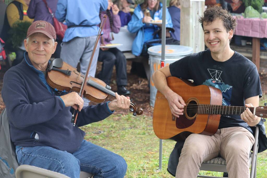 Tom Paul, left, and Henry Colt were just two of several musicians to provide music all throughout Saturdays Harvest Fair. (Jonson Kuhn / Juneau Empire)