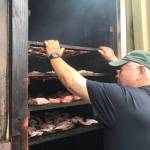Mickey Prescott puts racks in the smokehouse, Wrangell. (Vivian Faith Prescott / For the Capital City Weekly)