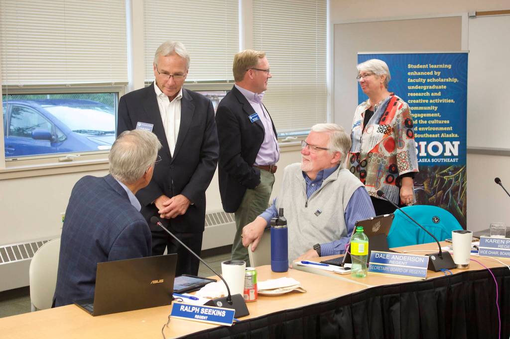 Members of the University of Alaskas Board of Regents chat during a break in their meeting Thursday at the University of Alaska Southeast. (Mark Sabbatini / Juneau Empire)