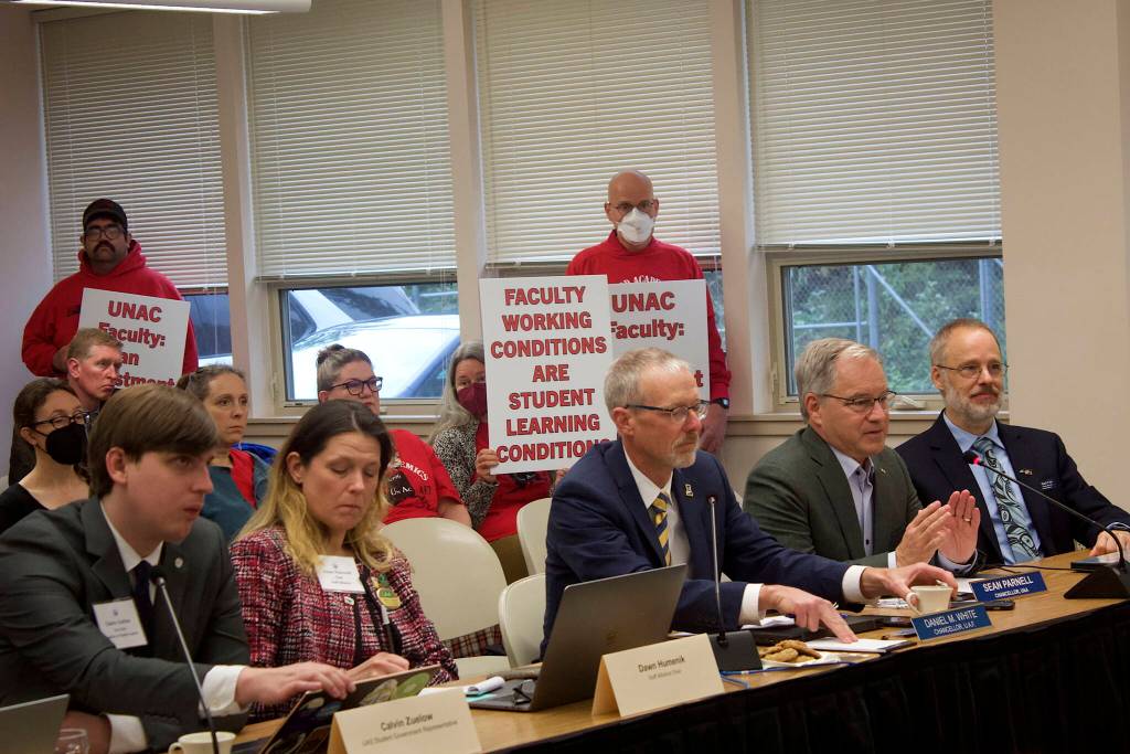 Sean Parnell, a former Alaska governor and current chancellor at the University of Alaska Anchorage, discusses partnerships with local schools and other community groups during the University of Alaskas Board of Regents meeting Thursday at the University of Alaska Southeast. In the background employees with the facultys union hold up signs protesting a stalemate in contract negotiations that has lasted more than a year. The two-day meeting continuing Friday is the boards first in Juneau since 2018. (Mark Sabbatini / Juneau Empire)