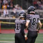 Jarrell Williams (1) and Thomas Baxter (84) celebrate a big play on defense early in Juneau's win over the visiting West Valley Rams. (Ben Hohenstatt / Juneau Empire)