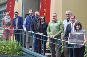 From left to right, Alison Sacks, David Gomez, Alec Mesdag, Justin Kanouse, Jennifer Meyer, Doug Simon, Larry Magura, Greg Kinney, and Gaye Willis. Each of them in various ways were instrumental in recognizing the Salmon Creek Dam as a National Historic Civil Engineering Landmark on Saturday, Sept. 10 at the Juneau-Douglas Museum. The late AEL&P Civil Engineer Scott Willis was also given a dedication with a memorial plaque that will hang next to the Salmon Creek Dam dedication plaque at Salmon Creek Trailhead. (Jonson Kuhn / Juneau Empire)