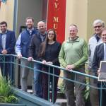From left to right, Alison Sacks, David Gomez, Alec Mesdag, Justin Kanouse, Jennifer Meyer, Doug Simon, Larry Magura, Greg Kinney, and Gaye Willis. Each of them in various ways were instrumental in recognizing the Salmon Creek Dam as a National Historic Civil Engineering Landmark on Saturday, Sept. 10 at the Juneau-Douglas Museum. The late AEL&P Civil Engineer Scott Willis was also given a dedication with a memorial plaque that will hang next to the Salmon Creek Dam dedication plaque at Salmon Creek Trailhead. (Jonson Kuhn / Juneau Empire)