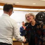Mila Cosgrove shakes hands with Sen. Jesse Kiehl after receiving a plaque from the members of the Thirty-Second Alaska State Legislature that honored her for her state service. (Clarise Larson / Juneau Empire)