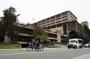Clarise Larson / Juneau Empire
A cycle rickshaw passes the North State Office Building parking garage located on Willoughby Avenue in downtown Juneau. The City and Borough of Juneaus Assembly passed an ordinance unopposed Monday night that gave the OK for the appropriation of $5 million to go toward partially funding the planning and construction of additional parking levels.