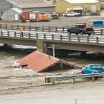 A home that was knocked off its foundation and floated down Snake River during a severe storm in Nome, Alaska, is caught under a bridge Saturday, Sept. 17, 2022. Much of Alaskas western coast was battered by the storm, which was the remnant of Typhoon Merbok, causing the most damage of any storm in the last half century. (AP Photo/Peggy Fagerstrom)