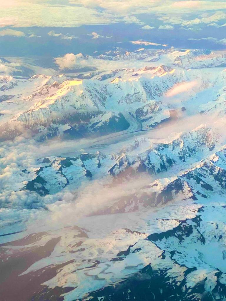 Sunset on snow-capped mountains between Anchorage and Juneau. (Courtesy Photo / Denise Carroll)