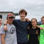 From left to right, Thunder Mountain High School senior cross country runners Michael Wittig, Justus Paden, Ben Erickson, Aliyah Overturf and Mackenzie Olver smile for picture after cross country practice on Monday afternoon. (Clarise Larson / Juneau Empire)