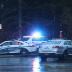 Several police vehicles, including a mobile incident command vehicle, were present Wednesday evening near the Kaxdigoowu Héen Dei (Brotherhood Bridge Trail) trailhead. (Ben Hohenstatt / Juneau Empire)