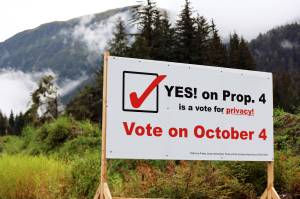 A sign encouraging voters to vote yes on Proposition 4 stands at a busy Mendnehall Valley intersection. The proposition to repeal a city ordinance requiring buyers to disclose the sales price of real property has been a flashpoint in the municipal election with groups forming in support and opposition of the proposition. (Ben Hohenstatt / Juneau Empire)