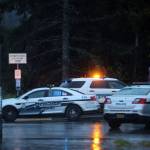 Police vehicles gather Wednesday evening near Kaxdigoowu Héen Dei, also known as ]]Brotherhood Bridge Trail, while investigating what police have described as a suspicious death. (Ben Hohenstatt / Juneau Empire)