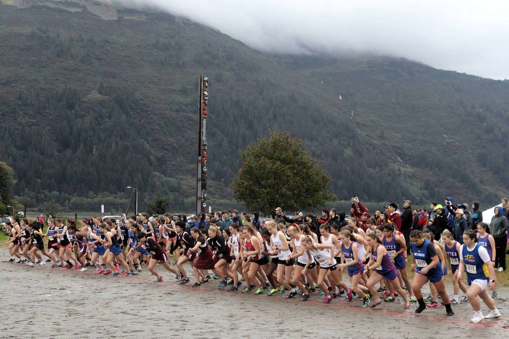 Eighty-four girls from Southeast Alaska high schools set out from the starting line of the Capital City Invites 5K race on Saturday. All but three of the runners completed the muddy course. (Mark Sabbatini / Juneau Empire)