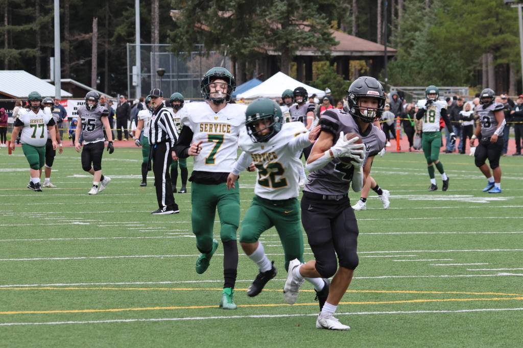 Jayden Johnson nears the goal line after catching a long pass from Jarrell Williams. Johnson scored twice in a 49-32 win against Service High School. (Ben Hohenstatt / Juneau Empire)