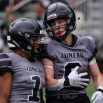 Jarrell Williams (1) talks to Payton Grant (9) during a 49-32 win against Service High School. The seniors had big games against the Cougars. Williams rushed for two touchdowns and threw for a score  all in the first quarter. Grant also rushed for a score and broke up passes in key moments on defense. (Ben Hohenstatt / Juneau Empire)