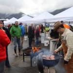 Rodney Hesson, assistant business manager of the local IBEW chapter, cooks burgers during the ninth annual Juneau EV & EBIKE Roundup on Saturday. He said hes still driving a gas-powered truck because his wife is waiting for the debut of electric-powered VW Bus. (Mark Sabbatini)