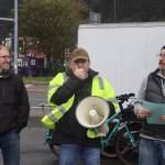State Sen. Jesse Kiel of Juneau, left, Duff Mitchell, managing director of Juneau Hydropower, center, and Juneau Assembly Member Wade Bryson talk about the local state of electric vehicles during the ninth annual Juneau EV & EBIKE Roundup on Saturday. Mitchell said there were six electric vehicles in Juneau during the first roundup, compared to 600 to 700 today. (Mark Sabbatini / Juneau Empire)