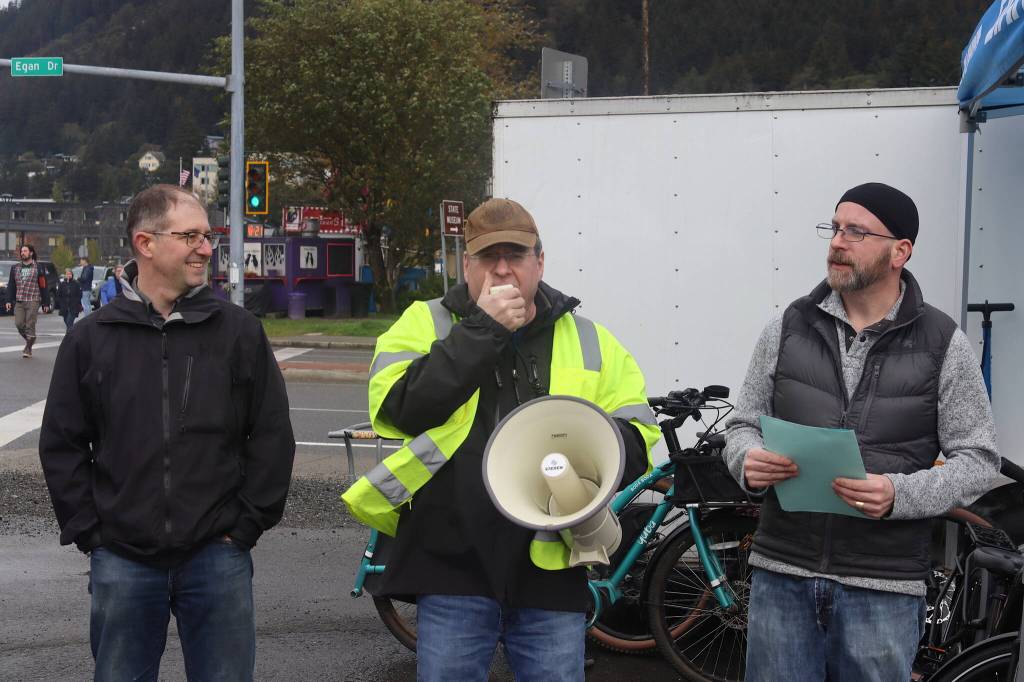 State Sen. Jesse Kiel of Juneau, left, Duff Mitchell, managing director of Juneau Hydropower, center, and Juneau Assembly Member Wade Bryson talk about the local state of electric vehicles during the ninth annual Juneau EV & EBIKE Roundup on Saturday. Mitchell said there were six electric vehicles in Juneau during the first roundup, compared to 600 to 700 today. (Mark Sabbatini / Juneau Empire)