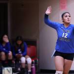 Moana Tuvaifale serves for TMHS while other volleyball players look on. (Ben Hohenstatt / Juneau Empire)