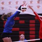 Mallory Welling spikes the ball during a game at Juneau-Douglas High School: Yadaa.at Kalé on Friday while teammate Ashlyn Gates looks on. (Ben Hohenstatt / Juneau Empire)