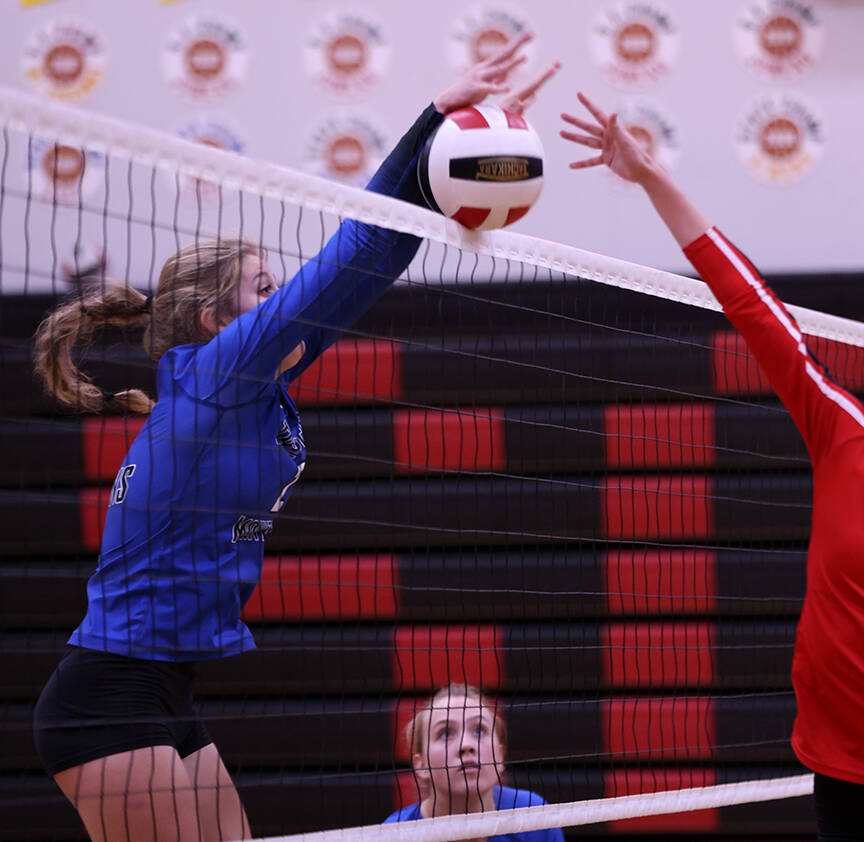 Mallory Welling spikes the ball during a game at Juneau-Douglas High School: Yadaa.at Kalé on Friday while teammate Ashlyn Gates looks on. (Ben Hohenstatt / Juneau Empire)