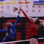 TMHS Ashlyn Gates and JDHS Mila Hargrave both reach for the ball during the second set of a cross-town volleyball match held at JDHS on Friday. (Ben Hohenstatt / Juneau Empire)