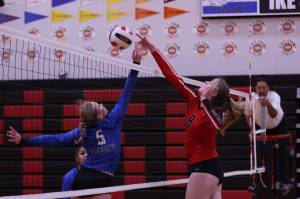 TMHS Ashlyn Gates and JDHS Mila Hargrave both reach for the ball during the second set of a cross-town volleyball match held at JDHS on Friday. (Ben Hohenstatt / Juneau Empire)