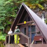Visitors take in the view from the porch of the U.S. Forest Services Mount Flemer Cabin in the Wrangell Ranger District. The Forest Service is preparing to accept public input on how to spend about $14.4 million in federal funds for new cabins and repairing existing ones in Alaska, including an anticipated 10 to 12 new cabins in the Tongass National Forest. (U.S. Forest Service photo)