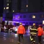 Capital City Fire/Rescue officials walk back to the fire trucks sitting downtown. (Clarise Larson / Juneau Empire)