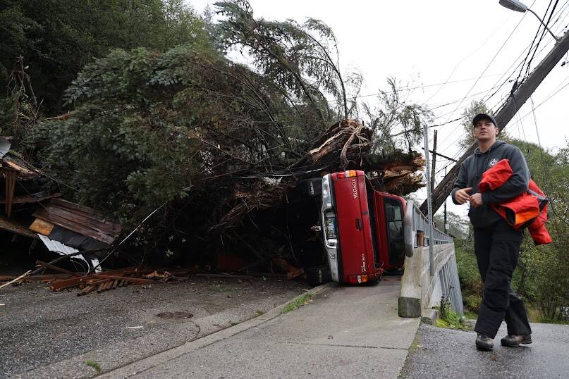 Clarise Larson / Juneau Empire
A CCFR responder was at the site of major wreckage on Gastineau Avenue that was caused due to a landslide during a heavy rainstorm Monday evening. The slide knocked a tree down across Gastineau Avenue, destroying a power pole that resulted in power outages around Juneau and causing other wreckage on the residential street.