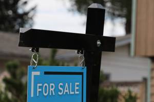 A fore sale sign hangs outside of a Juneau residence. (Clarise Larson / Juneau Empire File)