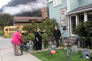 Mindy and Will Jones, who lived next door to Resurrection Lutheran Church, talk to neighbor Elva Bontrager in their yard on Wednesday. The couple said they are sympathetic to disadvantaged residents staying at the church’s warming shelter during sub-freezing winter nights, but there have been incidents with people being loud and rowdy outside late at night. The church provided the warming shelter for the first time last winter and on Tuesday the city approved extending the number of days and hours the shelter can be open during the coming winter.  (Mark Sabbatini / Juneau Empire)
