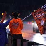 Keagan Hasselquist, 15, holds up a flag bearing the message "Every child matters" during an Orange Shirt Day event Friday morning in Juneau. The event started at 6:45 a.m. Hasselquist said he usually isn't out and about at that time "but I'm doing good with it so far." He said it was awesome to see strong turnout for the event)(Ben Hohenstatt / Juneau Empire)