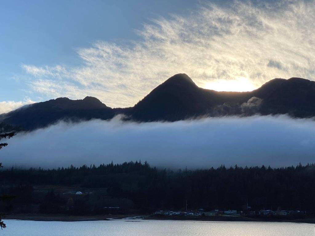 A cloud like a strip of cotton batting stretches across the mountains known as the three sisters on Oct. 17. (Courtesy Photo / Denise Carroll)
