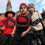 Children from the Tlingit Culture Language and Literacy Dance Group perform in front of the totem pole before its unveiling. (Clarise Larson / Juneau Empire)