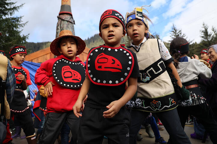 Children from the Tlingit Culture Language and Literacy Dance Group perform in front of the totem pole before its unveiling. (Clarise Larson / Juneau Empire)