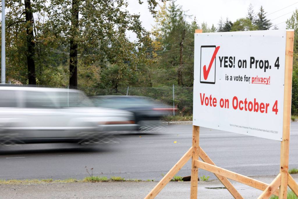 Cars drive past a sign encouraging voters to support Proposition 4, which would repeal a local ordinance requiring the disclosure of the sales price of real property. The proposition was heavily supported by local Realtors. (Ben Hohenstatt / Juneau Empire File)