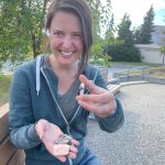 Kelsey Aho shows ceramic tiles she created from minerals gathered around Alaska. (Courtesy Photo / Ned Rozell)