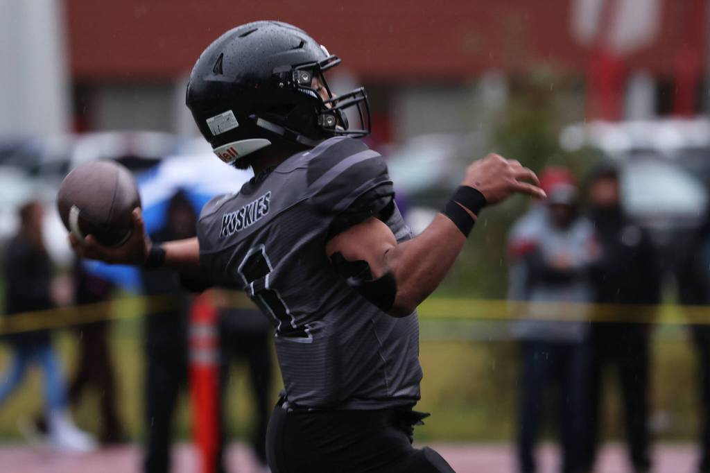 Jarrell Williams winds up for a long throw. The pass would fall incomplete but draw a drive-extending pass interference penalrty. (Ben Hohenstatt / Juneau Empire)