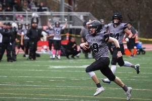Payton Grant makes his way to the end zone for his and the Huskies first touchdown of the game as his teammates signal the score. Grant, a senior, had a big day for Juneau. (Ben Hohenstatt / Juneau Empire)