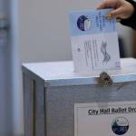 A ballot is placed in a drop box on Tuesday, Oct. 4, during the City and Borough of Juneau municipal election. Voters could cast ballots by mail, at voting centers located at City Hall and the Mendenhall Valley Public Library or at secure drop boxes at Don D. Statter Harbor and at the Douglas Public Library/ Fire Station. (Ben Hohenstatt / Juneau Empire File)