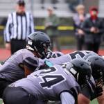 The Juneau Huskies offense prepares to kneel to end the half against the Bettye Davis East Anchorage High School Thunderbirds.