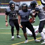 Jarrell Williams (1) smiles after securing what was essentially a game-ending interception. Payton Grant (9) and Thomas Baxter (84) react to the big play. After the big play, the Huskies offense would take the field for victory formation. (Ben Hohenstatt / Juneau Empire)
