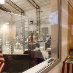 Members of the Canvass Review Board stand and sit as a group inside the CBJ Ballot Processing Center Monday morning. The board members and other city officials began the election certification process Monday morning and are expected to announce the final results on Wednesday. (Clarise Larson / Juneau Empire)