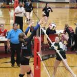 Ashlyn Gates of Thunder Mountain High School deflects the ball past a Craig High School player during the Gold Bracket semi-final game of the Juneau Invitational Volleyball Extravaganza at Juneau-Douglas Yadaa.at Kalé High School on Saturday. TMHS, the top seed in the six-team bracket, lost the title game to Chugiak High School. (Mark Sabbatini / Juneau Empire)