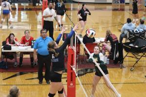Ashlyn Gates of Thunder Mountain High School deflects the ball past a Craig High School player during the Gold Bracket semi-final game of the Juneau Invitational Volleyball Extravaganza at Juneau-Douglas Yadaa.at Kalé High School on Saturday. TMHS, the top seed in the six-team bracket, lost the title game to Chugiak High School. (Mark Sabbatini / Juneau Empire)