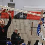 Gwen Nizich, a freshman at Juneau-Douglas Yadaa.at Kalé High School, taps the ball over the net on her home court during the Juneau Invitational Volleyball Extravaganza on Saturday. (Mark Sabbatini / Juneau Empire)