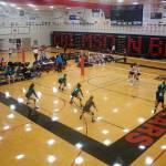 Teams face off on the twin courts of the main gym at Juneau-Douglas Yadaa.at Kalé High School during the Juneau Invitational Volleyball Extravaganza on Saturday. A third set of games was plated in the schools auxiliary gym. (Mark Sabbatini / Juneau Empire)