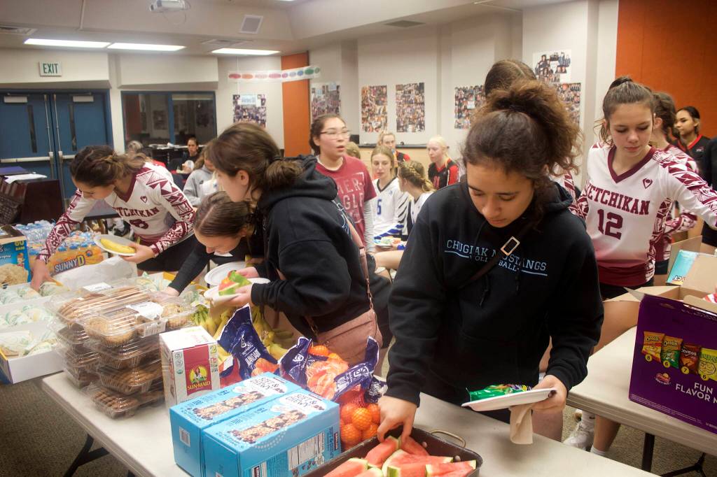 Students from 11 Alaska high schools take a lunch break Saturday during the two-day marathon of matchups during the Juneau Invitational Volleyball Extravaganza at Juneau-Douglas Yadaa.at Kalé High School. (Mark Sabbatini / Juneau Empire)