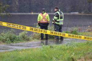 Juneau Police Department and assistance from Capital City Fire/Rescue on the scene Tuesday morning, Oct. 18 at Auke Bay Lake off of Glacier Highway after it was reported that a white Chevrolet pickup truck occupied by three males lost control and rolled several times before landing into the lake. (Jonson Kuhn / Juneau Empire)